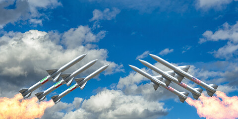 Naklejka premium Six white missiles with Iranian and American flag markings launch simultaneously into a partly cloudy blue sky, symbolizing tension between Iran and the USA through military action imagery