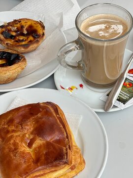 Traditional Portuguese Breakfast with Pastel de Nata Egg Tarts and Galao Coffee
