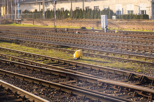 A vast network of parallel train tracks bathed in bright afternoon sunlight, symbolizing modern railway transportation infrastructure, urban connectivity, and forward movement