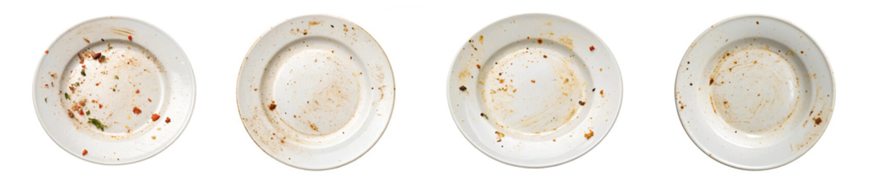 collection of dirty white plates with leftover food remnants and greasy stains, photographed from above after a meal.