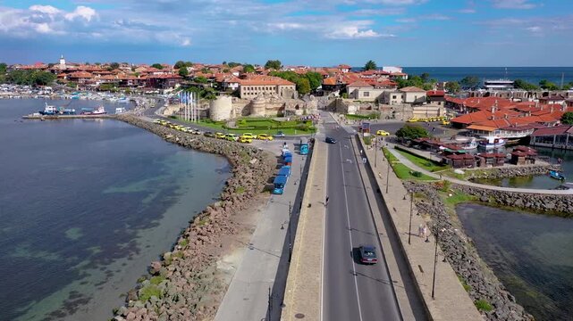 Wooden windmill on a dyke in in Nesebar historic city on Black Sea shore in Bulgaria, 4k