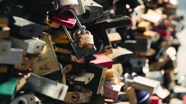 Close up of many padlocks that couples attached to the bridge to symbolize love.
