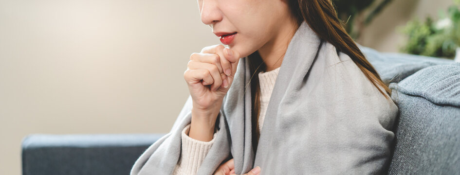 young woman feeling pain in her throat from sore throat.