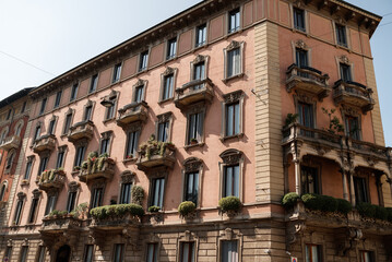 Fototapeta premium historical buildings in milan in italy. Beautiful architecture, the atmosphere of the old town, cozy balconies with flowers.