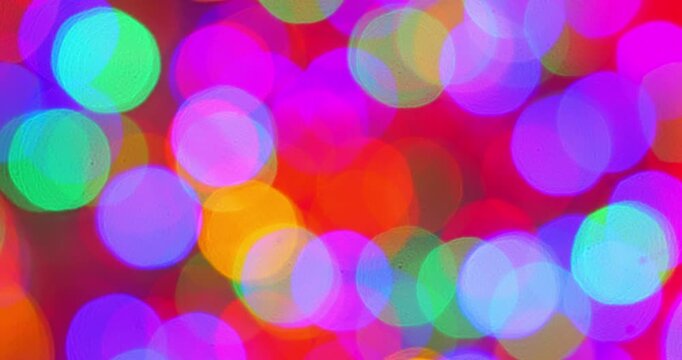 Vibrant Multicolored Bokeh Lights. Abstract video background featuring blurred neon light orbs in vibrant hues with gentle color shifts.