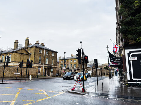 London street scene with pedestrians, traffic lights and brick buildings in England