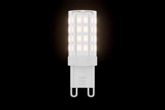 An LED bulb with a G9 base and a clear polycarbonate cap glows against a black background. 3D render.
