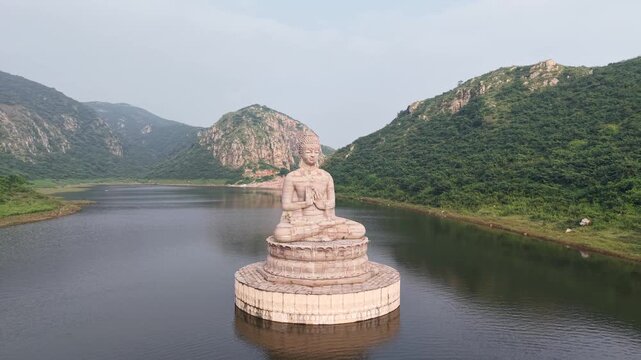 Aerial View of Giant Buddha Statue in Lake Surrounded by Hills Rajgir Bihar India