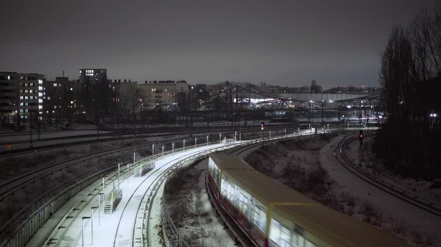 Train going into the city of Berlin at night in winter time