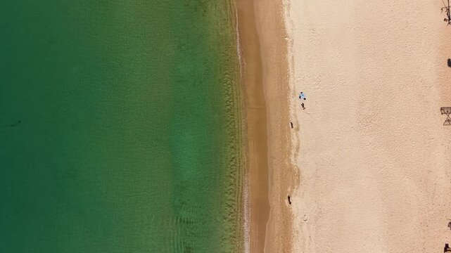 Aerial drone video of Khlong Chak Beach on Koh Lanta Island, Thailand. Capturing turquoise waters and sandy shore from above. Tropical paradise with serene atmosphere.