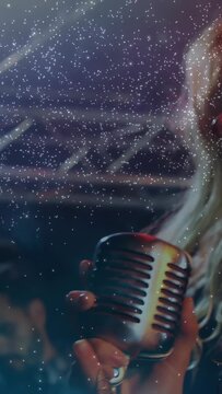Vertical video: Singer starting singing into mic camera receding stars drifting over face emoting