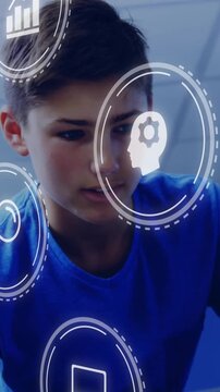 Vertical video: Boy leaning, tracking reaching, causing learning AR icons showing book target