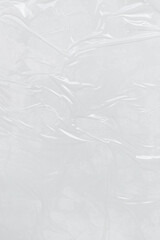 Obraz premium Vertical transparant wrinkled plastic, white plastic or polyethylene bag texture, macro, white background