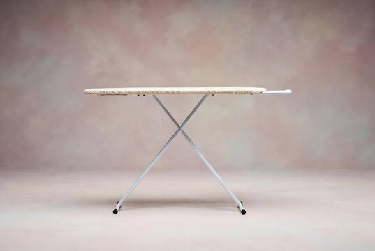 A folding ironing board is on a light-colored floor.
