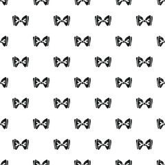 Fototapeta premium Black bow ties forming a seamless pattern on white background