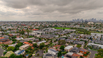 Obraz premium Panoramic Aerial Drone view of Inner Suburbs of Melbourne housing, roof tops, the streets and the parks, the roads and trees of Ascot Vale Moonee Ponds Brunswick Essendon and Maribyrnong in VIC Victor