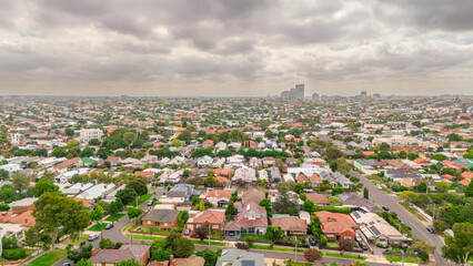 Fototapeta premium Panoramic Aerial Drone view of Inner Suburbs of Melbourne housing, roof tops, the streets and the parks, the roads and trees of Ascot Vale Moonee Ponds Brunswick Essendon and Maribyrnong in VIC Victor