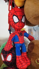 Fototapeta premium Spider-Man plush toy hanging with other characters