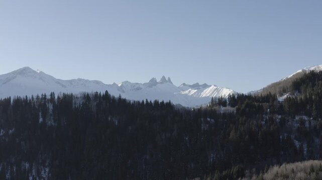 Apparition pic des aiguilles d'armes au dessus de for&ecirc;t enneig&eacute;e