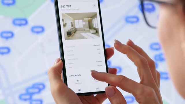 Real Estate Agent Carefully Searches Property Listings Online Using Computer