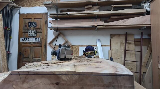 Professional Maker Conducting Quality Audit and Executing Corrective Leveling on Timber Slab with Power Planer