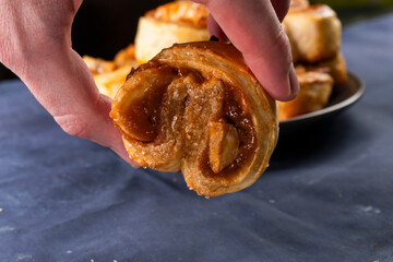 Freshly baked banana caramel puff pastry rolls on a baking sheet. Pastry. Dessert © Denis
