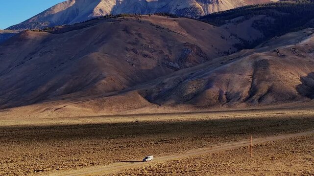 Golden valley floor with Borah Peak rising in background along Highway 93 Idaho