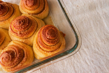 Fototapeta premium Sourdough cinnamon rolls in a glass baking pan 