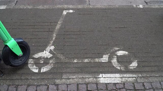  Electric scooter parking zone on city sidewalk, urban micro mobility and green transportation concept.