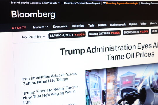 Computer screen displaying financial news website with market data and headlines. Digital editorial content for business information.