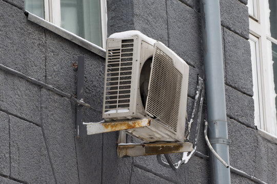 An external air conditioner unit damaged by an ice floe falling from the roof