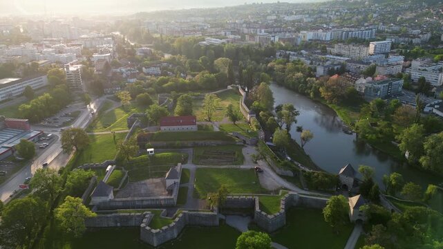 Morning aerial lateral shot of the Vrbas river and medieval Kastel fortress in Banja Luka, Republic of Srpska, Bosnia and Herzegovina, calm waters reflecting the early light.