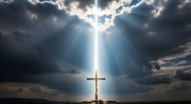 Wooden cross illuminated by dramatic light against stormy sky