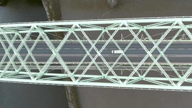 Liverpool, Merseyside, UK, September 09, 2025; aerial 4K video footage of the Silver Jubilee Bridge and Britannia Railway Viaduct over the River Mersey and Manchester Ship Canal, Runcorn, Merseyside