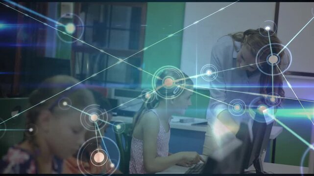 Kids typing and activating network overlay across computer lab while teacher assisting student