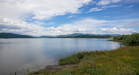 calm reservoir scene amid expansive natural landscapes and peaceful skies