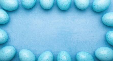 Obraz premium Creative flat lay of blue Easter eggs with speckles on textured blue surface featuring copy space