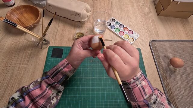 POV. woman coloring Easter eggs preparing to holiday at home. DIY work.