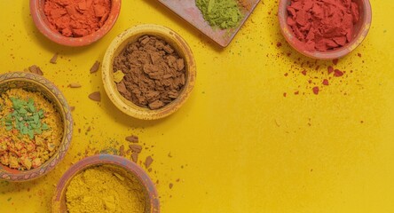 Obraz premium Colorful vibrant festival powders displayed in bowls with ample copy space on a bright backdrop