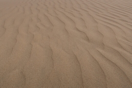 Sand texture with natural minimalist patterns - formed by natural erosion
