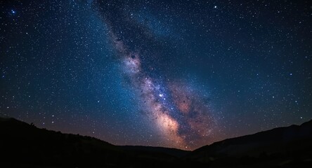 Fototapeta premium Cosmic summer night scene showcasing blue Milky Way and dazzling stars above hills