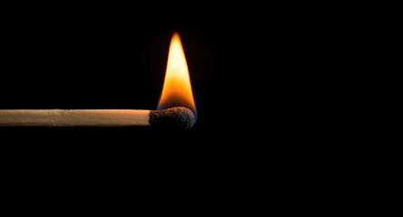 Detailed close up of a burning match tip with an understated blurred background