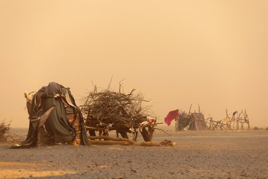 Hard sandstorm lashes the tents and shacks of an Amazigh nomadic campsite in the hamada (stone desert) near the Erg Chebbi dunes. Merzouga-Morocco-193