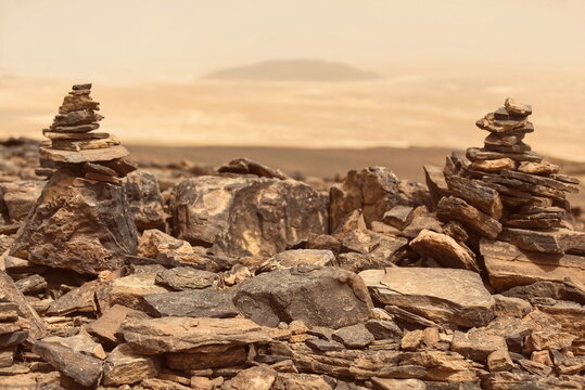 Cairns atop a mound placed between the Erg Chebbi and Erg Znaigui sand dune fields, a tourist spot known for its panoramic views. Merzouga-Morocco-197