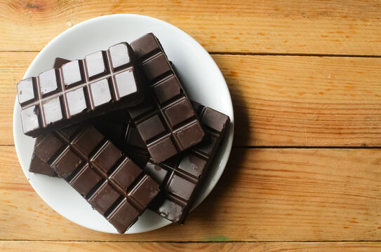 top view of chocolate bar on a wooden background