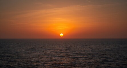 Dramatic sun at dusk over placid ocean nature frame