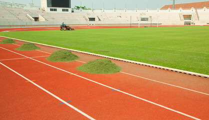 Fototapeta premium Cutting grass on the sports field