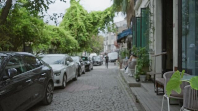Istanbul street blurred bokeh background showing cobblestone pavement and cafe terrace; backplate copyspace backdrop calm.