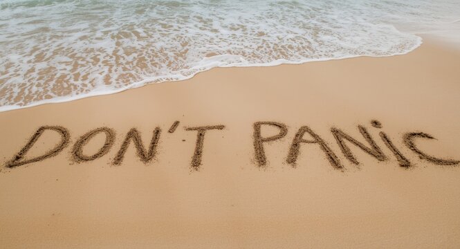Dont Panic slogan drawn clearly on smooth beach sand