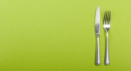 Culinary menu display with forks on a lively green textured backdrop featuring copy space for design